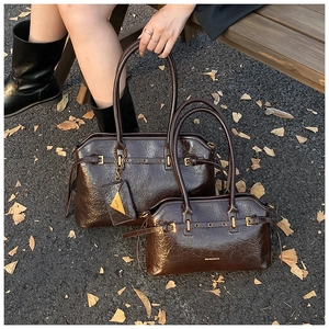 Deep brown glossy leather tote bag set shown on autumn street with ginkgo leaves