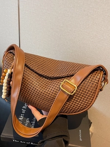 Fashionable woven brown straw dumpling bag with leather strap and decorative beads