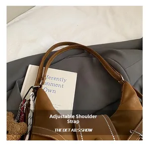 Detail showing the adjustable shoulder strap and contrast stitching on a vintage tote bag