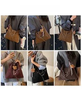 Detailed view of matte shoulder bags in multiple colors with bear pendant and metal buckles