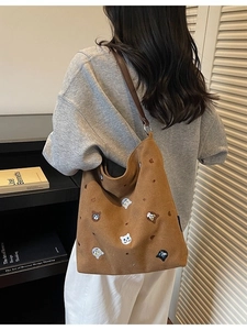 Brown canvas tote bag featuring cute cat embroidery and premium leather shoulder straps