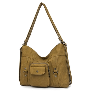 Detail of army green canvas tote bag featuring front snap pocket and metal rivet accents