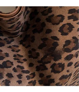 Detailed close-up of the leopard print fabric with smooth brown trim on a large tote bag