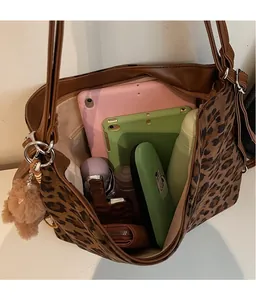 Close-up of leopard print tote bag interior showing large capacity and multi-pocket storage