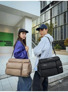 Detail of travel duffle bag with multiple pockets and water-resistant nylon material