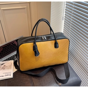 Détails du sac cabas bicolore avec cuir gingembre, anses noires et zip argent