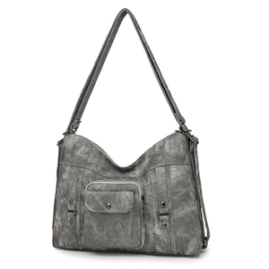 Detailed view of dark grey vintage tote bag featuring canvas texture and metal hardware