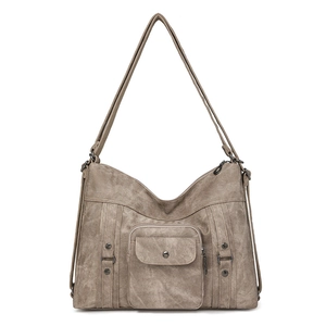 Detail of khaki textured canvas shoulder bag with front pocket and metal hardware