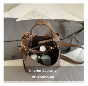 Macro view showing internal structure and large capacity of crocodile pattern bucket bag