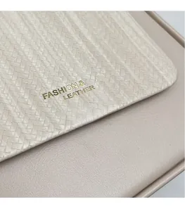 Macro detail of beige woven leather bag texture with gold fashion lettering
