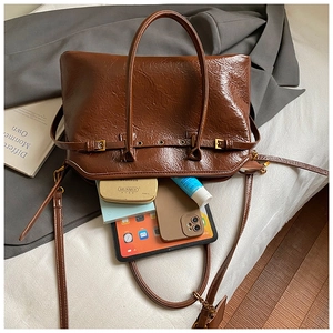 Top view of deep brown vintage tote bag showing spacious interior with daily essentials