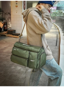 Olive green multi-pocket travel duffel bag showing durable nylon texture and side view