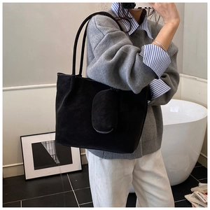 Detail showing large black suede tote bag with matching coin purse pouch for commuting