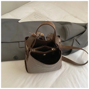 Brown crocodile embossed leather bucket bag with top handle and spacious interior