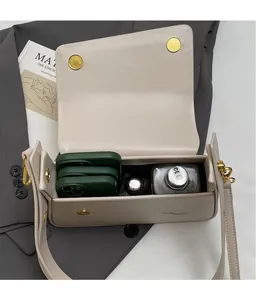 Detailed view showing the spacious interior of the beige leather shoulder bag