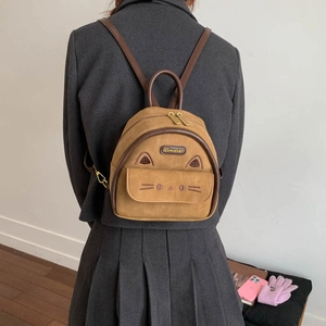Detail of vintage suede mini backpack with cute cat ears and embroidered kitten face