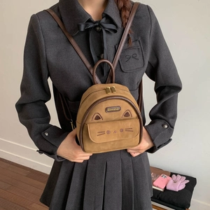Detail of vintage suede backpack with cute cat embroidery and 3D ears for students