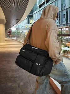 Large capacity black multi-pocket sports travel bag with wide adjustable shoulder strap