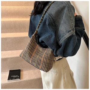 Detail view of a vintage multi-color woven hobo bag with stylish metal chain strap