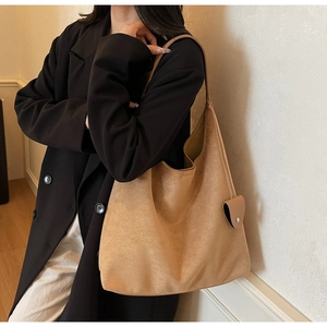 Detail of camel suede tote bag showing large capacity design and side coin purse attachment