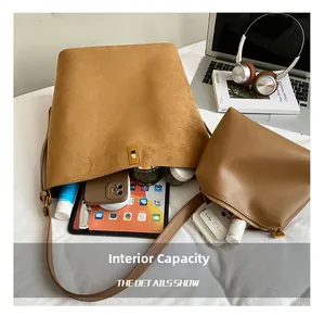 Macro view of suede bucket bag interior with matching pouch and daily essentials