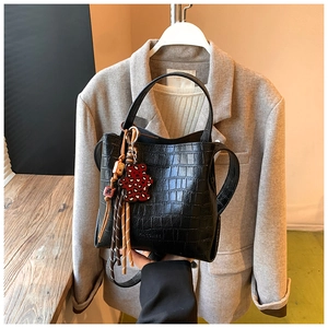 Black crocodile embossed bucket bag with leopard bear charm and colorful tassels
