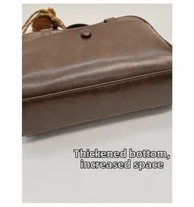 Detail showing the thickened bottom and increased storage capacity of the brown tote bag
