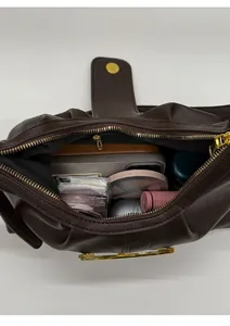 Macro shot showing the spacious interior compartment and zipper pocket of the brown tote bag