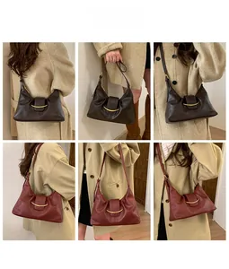 Detail of vintage tote bags in dark coffee and wine red with crescent metal accents