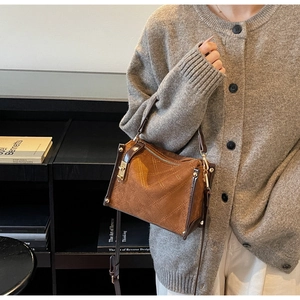 Close-up of vintage brown quilted handbag with gold clasp and elegant matte texture