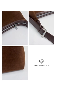 Detailed macro view of dark brown suede texture and silver metal buckle on the shoulder bag