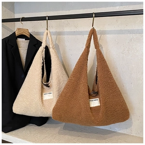 Close-up of fluffy teddy fleece tote bags with SEEYOU label and button closure