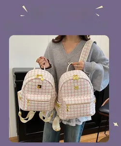 Pink plaid tweed backpack detail showing small and medium sizes with gold metal zipper