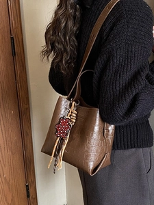 Brown crocodile embossed bucket bag with leopard print bear charm for stylish women