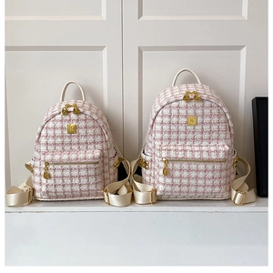 Comparison of large and small pink tweed backpacks with leather straps and gold logo