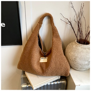 Detail of warm brown fleece tote bag with SEEYOU label and soft plush texture