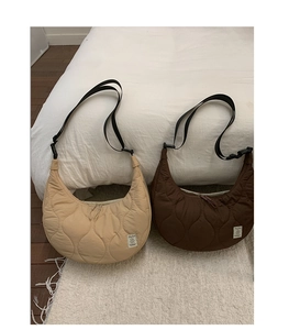 Dettaglio di borse a mezzaluna trapuntate in beige e marrone scuro in nylon leggero