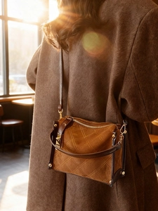 Brown vintage quilted shoulder bag with suede texture and gold hardware in natural light