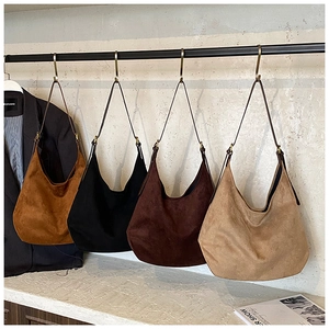 Macro detail of high-quality suede tote bags in four classic colors for women