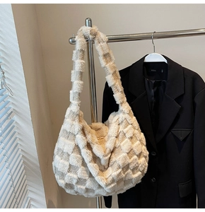 Detail of beige plush checkered tote bag showing quilted texture and soft winter fabric