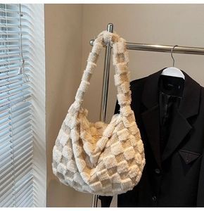 Detailed macro view of the soft plush checkerboard shoulder bag's furry texture