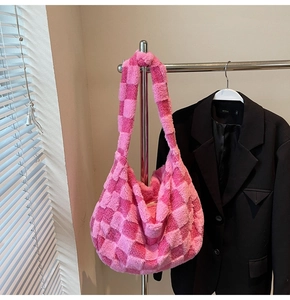 Detail of plush checkered shoulder bag in pink and magenta with soft faux fur texture