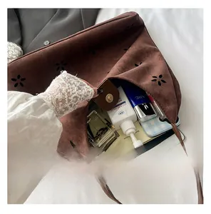 Spacious interior of brown suede tote bag showing large capacity for iPad and cosmetics