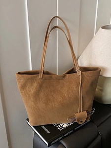 Brown faux suede large capacity tote bag for women with slim straps and round pendant