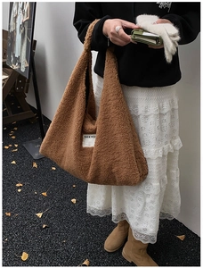Detail shot of a brown fleece tote bag with SEEYO label on fuzzy sherpa texture