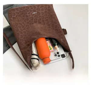 Leopard print tote bag interior showing capacity with water bottle and umbrella