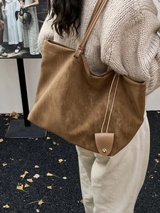 Brown suede large tote bag with slender straps and side leather charm for commute