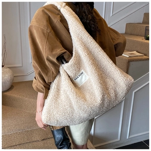 Detailed texture of beige faux fur tote bag with SEEYOU square label on surface