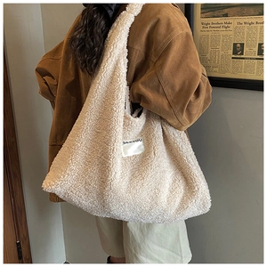 Detailed shot of plush sherpa tote bag texture with SEEYOU label in a retro autumn aesthetic