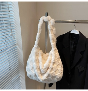Close-up of fluffy white plush hobo bag with textured checkered pattern and wide strap